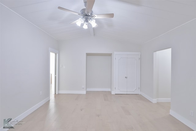 unfurnished bedroom featuring light wood-type flooring, ceiling fan, and vaulted ceiling