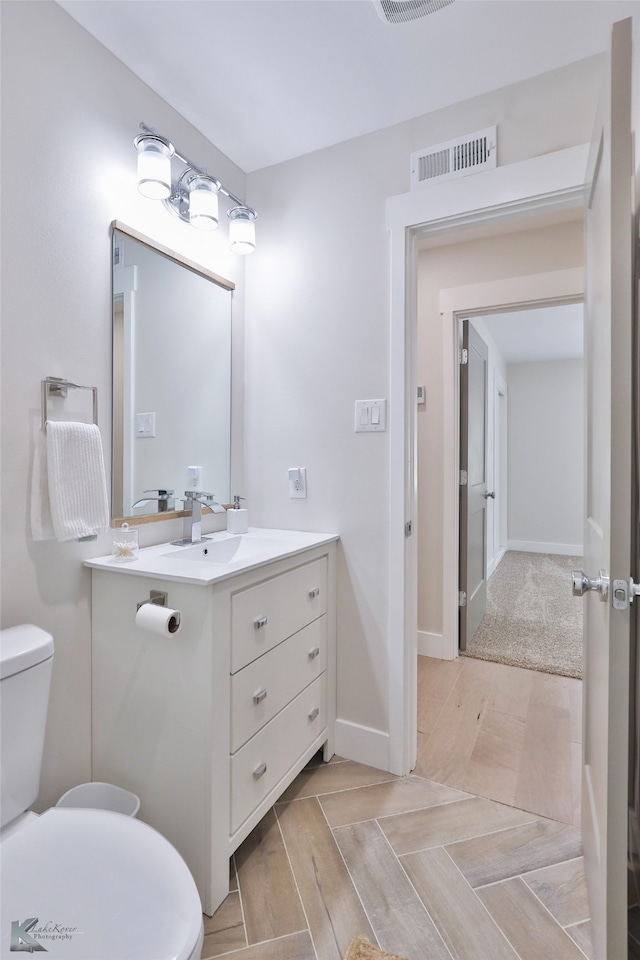 bathroom featuring vanity and toilet