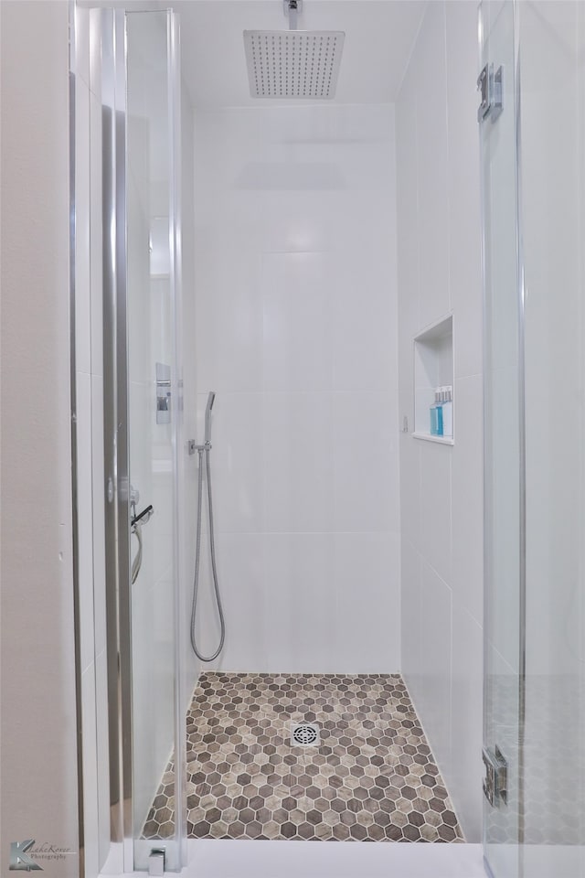 bathroom featuring a shower with door