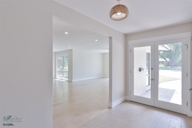 doorway to outside with light hardwood / wood-style flooring and french doors