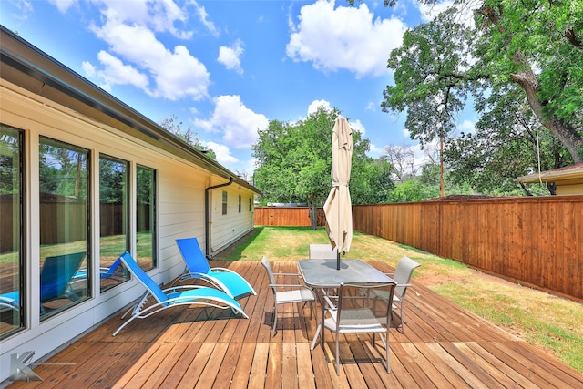 wooden terrace featuring a yard