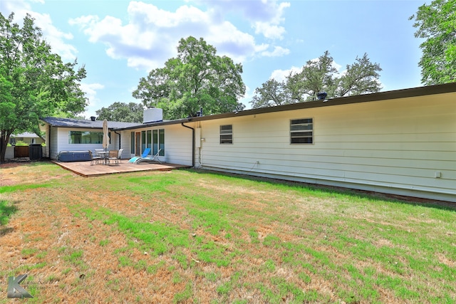 rear view of property featuring a lawn