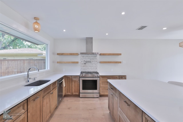 kitchen with light hardwood / wood-style floors, sink, wall chimney exhaust hood, and stainless steel appliances