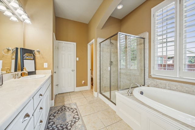 full bathroom featuring tile patterned floors, vanity, independent shower and bath, and toilet