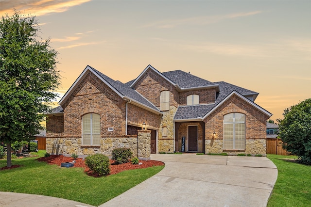 view of front facade featuring a lawn and a garage