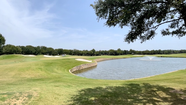 view of community featuring a yard and a water view