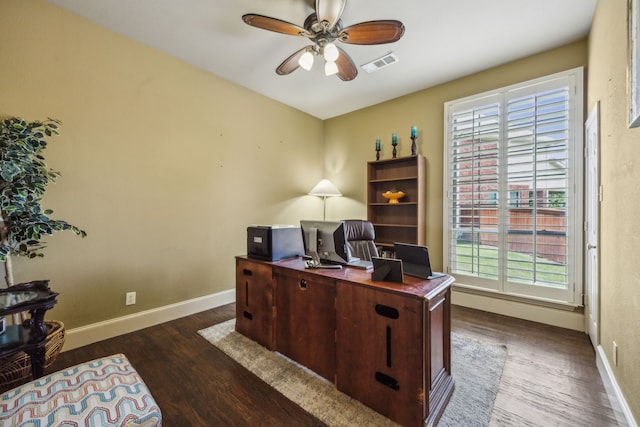 home office featuring ceiling fan and dark wood-type flooring