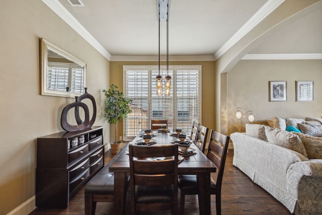 dining room with a chandelier, dark hardwood / wood-style floors, and crown molding