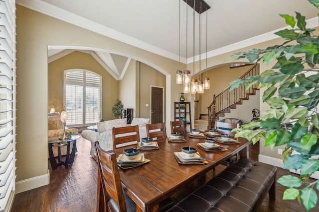 dining room with dark wood-type flooring, vaulted ceiling, and crown molding