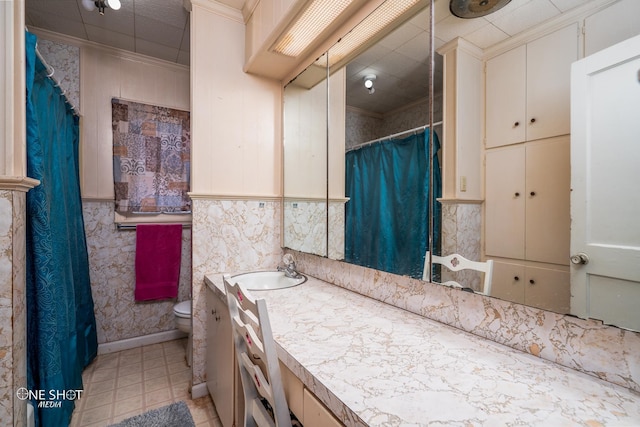 bathroom with vanity, ornamental molding, and toilet