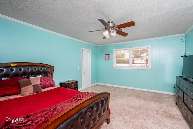 carpeted bedroom with ceiling fan, crown molding, and a textured ceiling