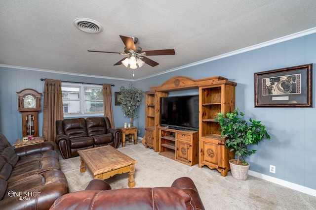 carpeted living room with a textured ceiling, ceiling fan, and crown molding