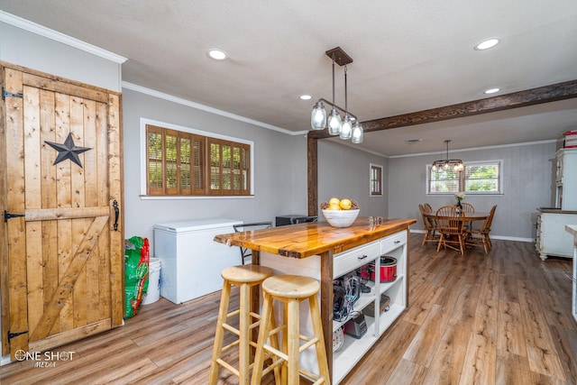 kitchen featuring light hardwood / wood-style floors, crown molding, fridge, and butcher block counters