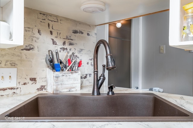 details with light stone countertops and sink