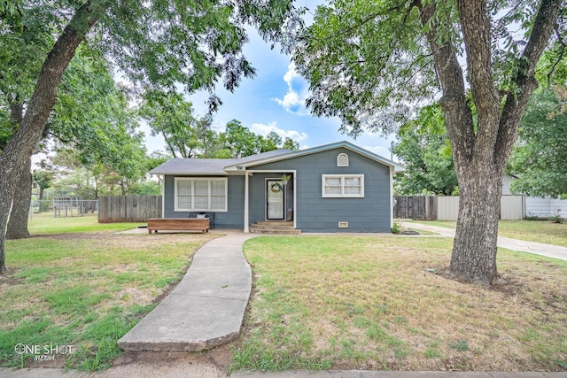 ranch-style home featuring a front yard