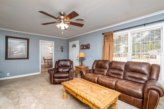 carpeted living room featuring crown molding, ceiling fan, and a textured ceiling