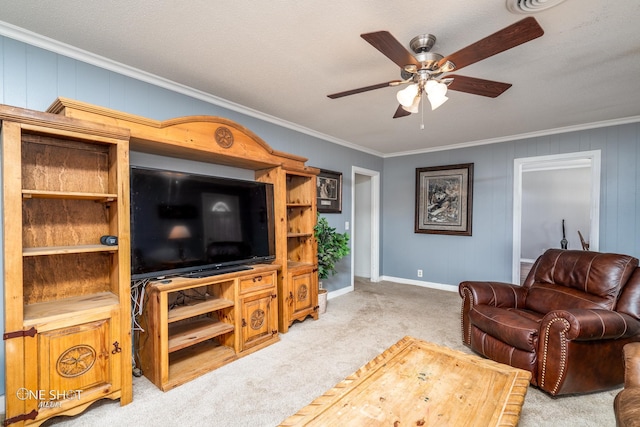 living room with a textured ceiling, ceiling fan, ornamental molding, and light carpet