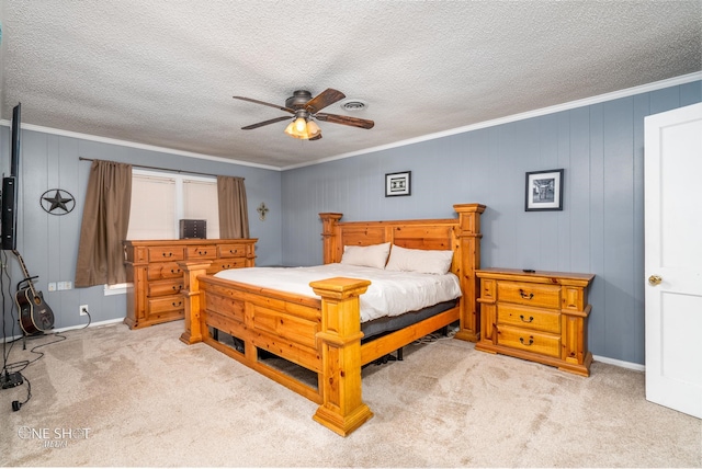 bedroom with ceiling fan, crown molding, and light colored carpet