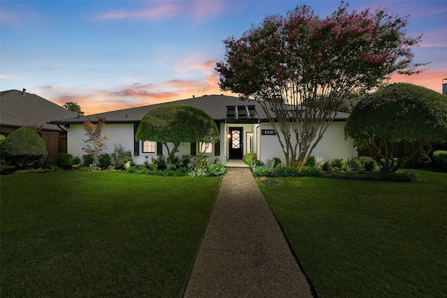 view of front of house featuring a lawn and a garage