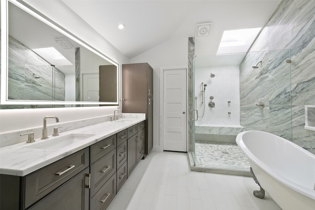 bathroom with plus walk in shower, vanity, and vaulted ceiling with skylight