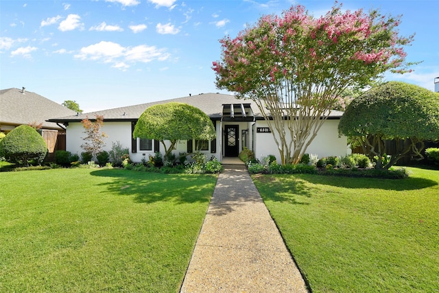 ranch-style house with a front lawn and a garage