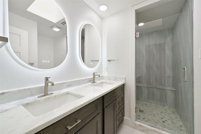 bathroom with a shower with door and vanity