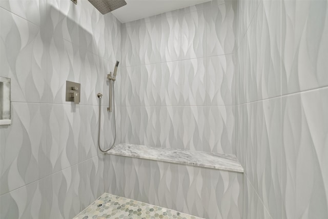 bathroom with tiled shower