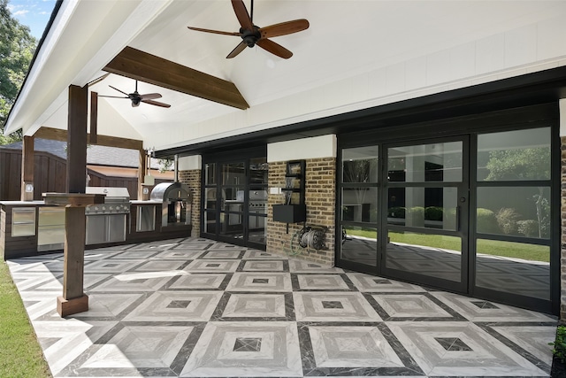 view of patio / terrace with a grill, ceiling fan, and exterior kitchen