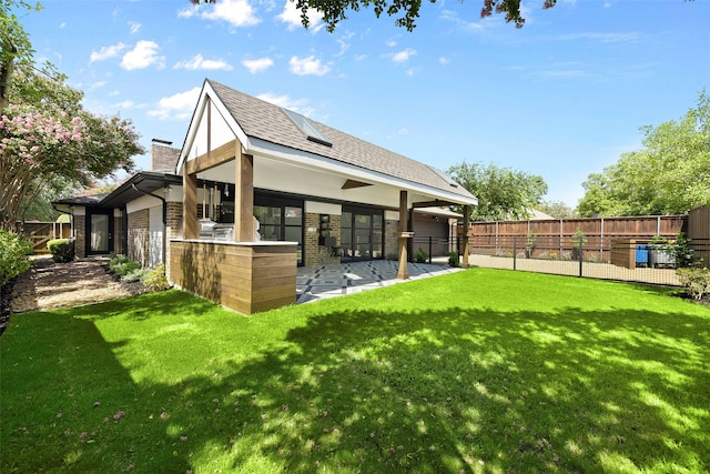 rear view of property featuring a lawn and a patio