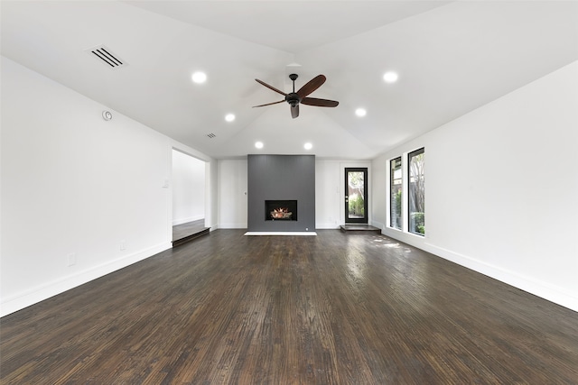 unfurnished living room featuring ceiling fan, a fireplace, dark wood-type flooring, and vaulted ceiling