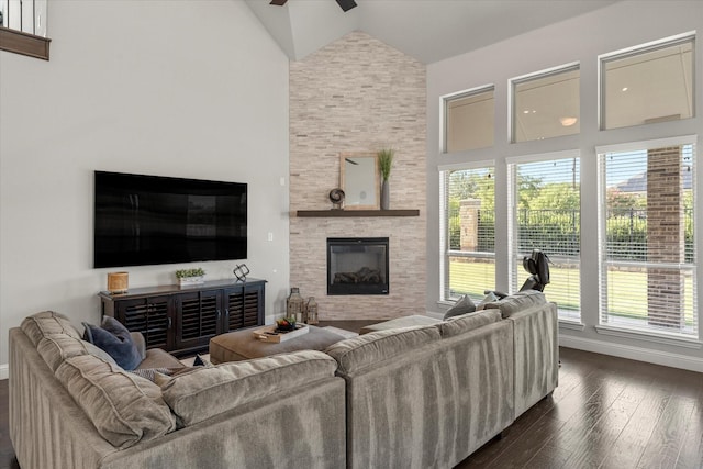 living room featuring a fireplace, high vaulted ceiling, dark hardwood / wood-style floors, and ceiling fan