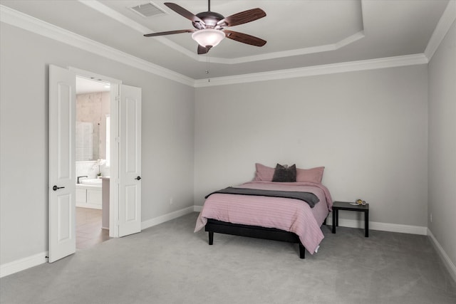 carpeted bedroom featuring a raised ceiling, crown molding, connected bathroom, and ceiling fan