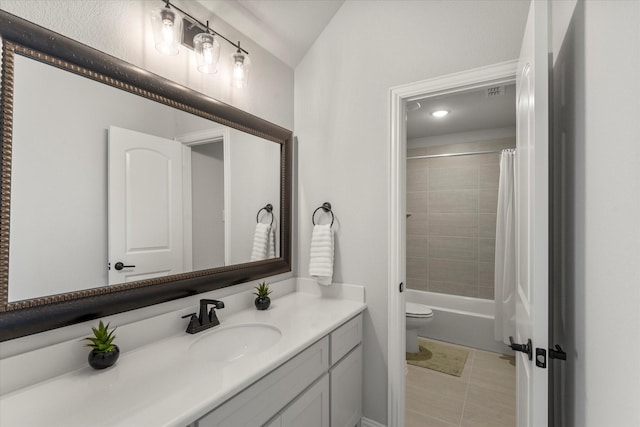 full bathroom featuring tile patterned floors, vanity, toilet, and shower / tub combo