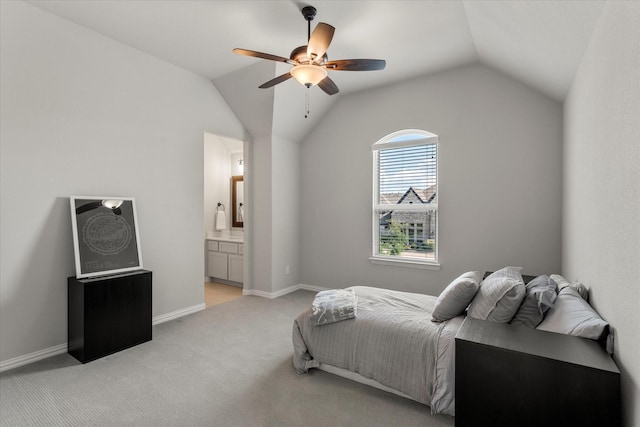 carpeted bedroom with ceiling fan, ensuite bath, and vaulted ceiling