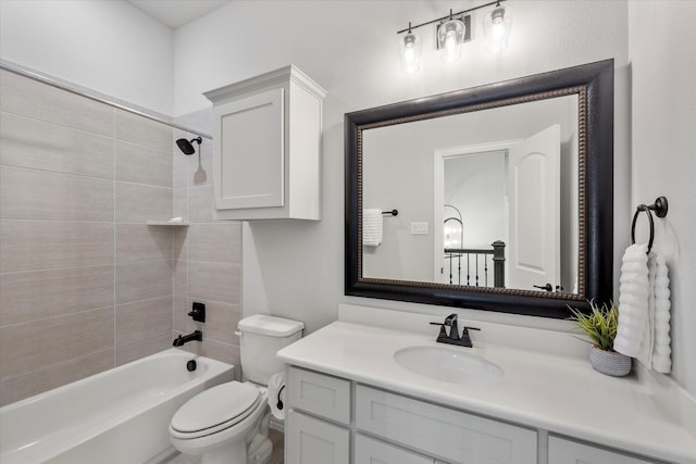 full bathroom featuring tiled shower / bath, vanity, and toilet