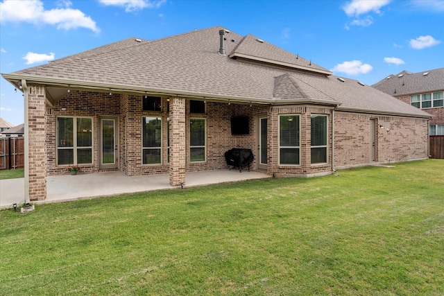 back of property featuring a patio area and a lawn