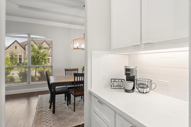 dining area with dark wood-type flooring and ornamental molding