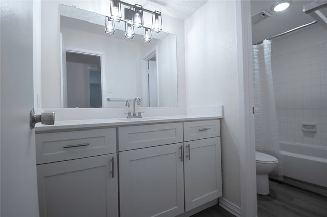 full bathroom featuring a textured ceiling, toilet, vanity, shower / bath combo, and wood-type flooring