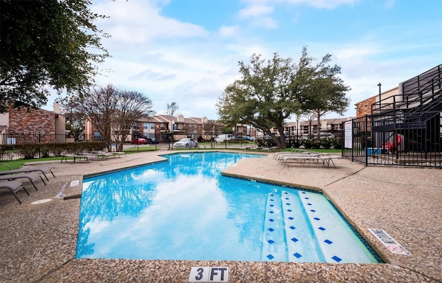 view of swimming pool with a patio area