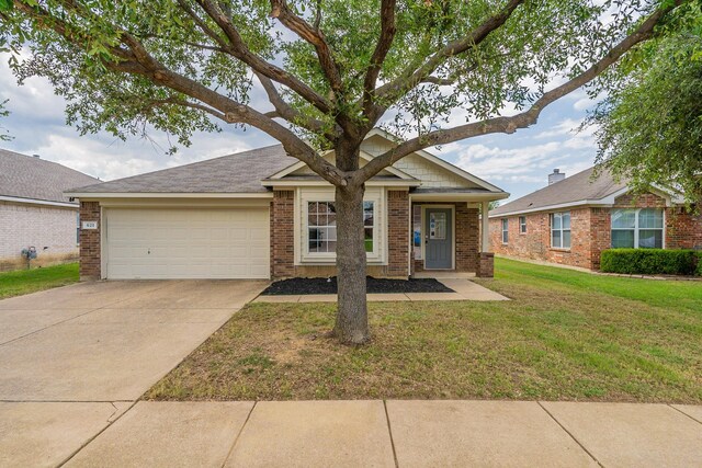 view of front of property with a front lawn and a garage