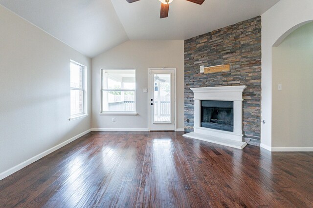 unfurnished living room featuring lofted ceiling, dark wood-type flooring, ceiling fan, and a fireplace