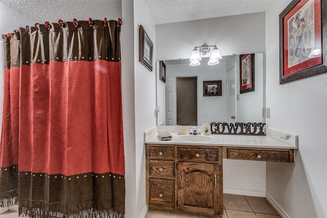 bathroom featuring vanity, tile patterned flooring, and a textured ceiling