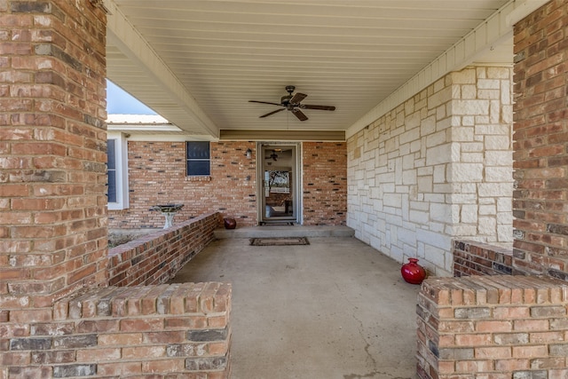 entrance to property with ceiling fan and a patio area