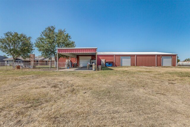 view of outdoor structure with a yard and a garage