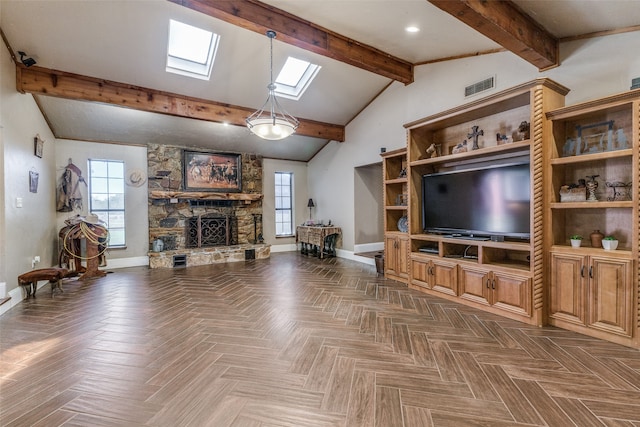 living room with vaulted ceiling with skylight, dark parquet floors, and a fireplace