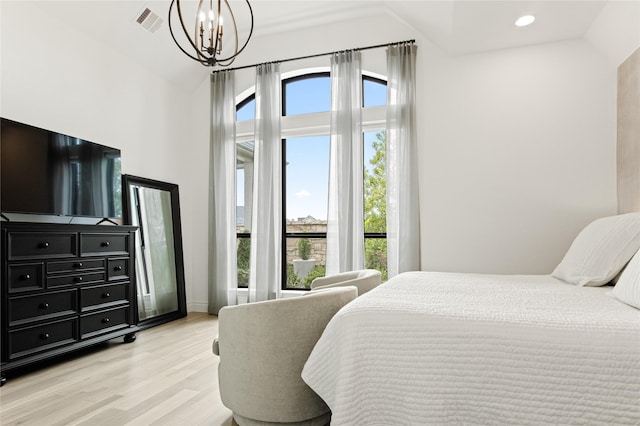 bedroom featuring visible vents, lofted ceiling, recessed lighting, light wood-style flooring, and an inviting chandelier