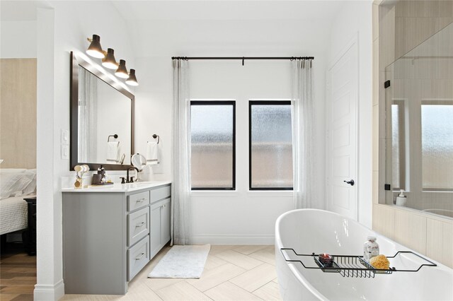 bathroom with vanity, a bathing tub, and tile patterned floors