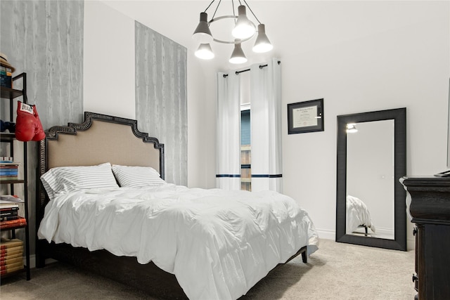 carpeted bedroom with a notable chandelier