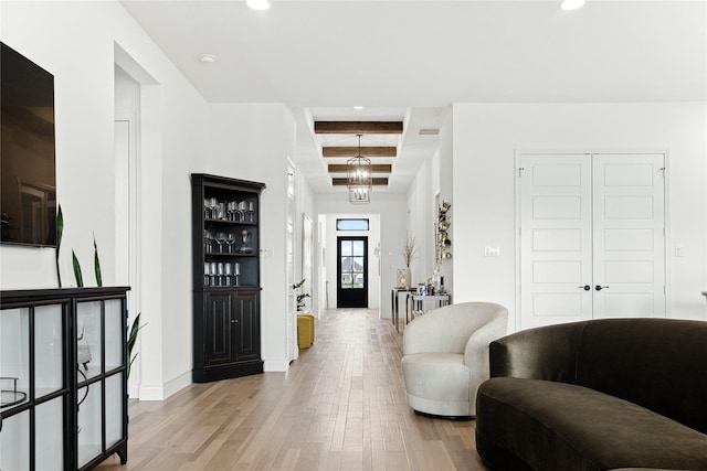 entryway featuring light wood finished floors, beamed ceiling, recessed lighting, and a notable chandelier