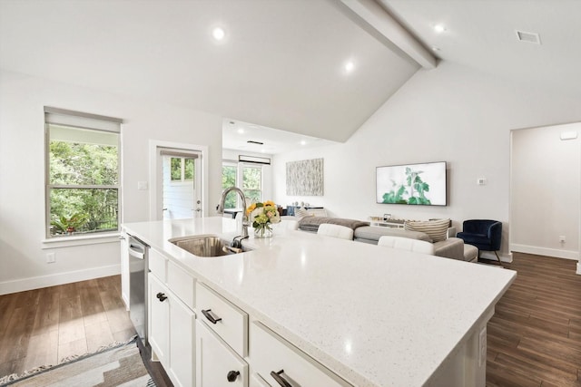 kitchen with white cabinetry, dark wood-type flooring, sink, and a center island with sink